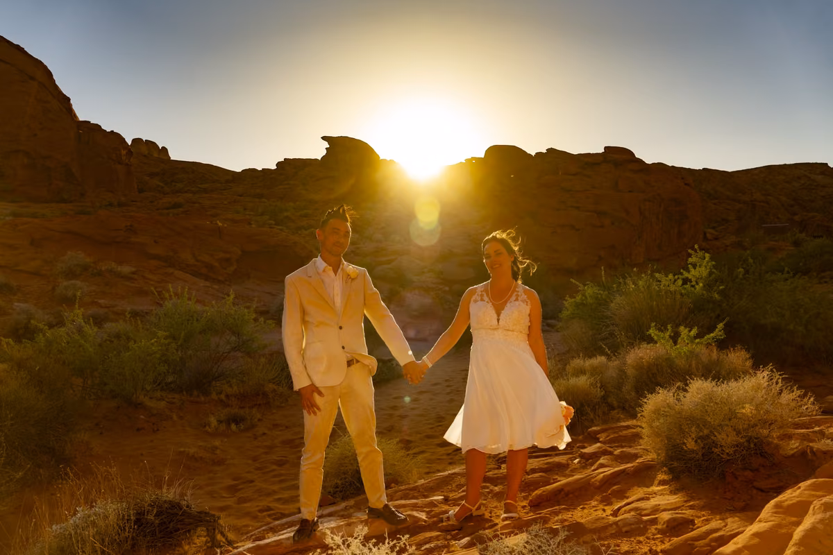 A couple holds hands as the sun sets over the red rock desert at Valley of Fire, an hour from Las Vegas.